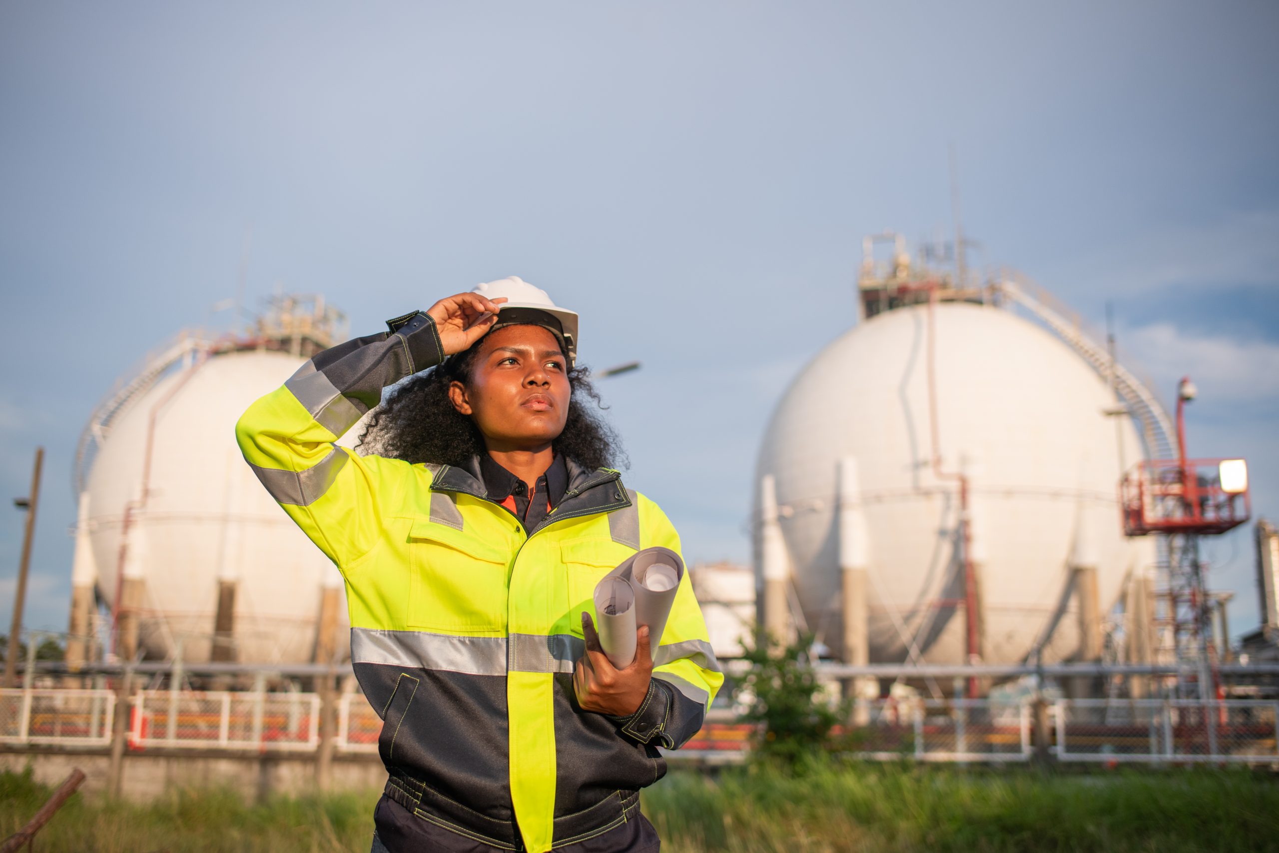 Engineers wearing safety gear, including hard hats examining sur